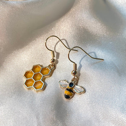 Cool quirky yellow and black gold bee drop dangle earrings with yellow honey comb